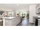 Open kitchen with granite island, stainless steel appliances, and gray cabinets at 331 Cheerful Way, Little River, SC 29566