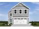 Two-story gray house with white garage doors and landscaping at 1092 Oak Meadow Dr., Conway, SC 29526