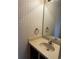 Small bathroom with beige vanity, toilet and patterned wallpaper at 610 14Th Ave. S # 181, Surfside Beach, SC 29575