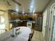 Kitchen with wood cabinets, white appliances, and an oval dining table at 3456 Macklen Rd. # 18-B, Myrtle Beach, SC 29588