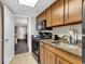 Kitchen with stainless steel sink and wood cabinets at 1105 Ocean Blvd. S # 412, Myrtle Beach, SC 29577