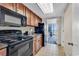 Well-equipped kitchen featuring black appliances and wood cabinets at 1105 Ocean Blvd. S # 412, Myrtle Beach, SC 29577