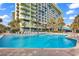 Large outdoor pool with surrounding lounge chairs and building view at 1105 Ocean Blvd. S # 412, Myrtle Beach, SC 29577