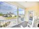 Covered porch with rocking chairs and a view of the neighborhood at 911 Ocean Pines Ct., North Myrtle Beach, SC 29582