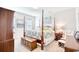 Main bedroom with post bed, ample natural light, and sitting area at 911 Ocean Pines Ct., North Myrtle Beach, SC 29582