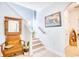 Inviting entryway with tiled floor, staircase, and antique bench at 911 Ocean Pines Ct., North Myrtle Beach, SC 29582