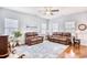 Relaxing living room with hardwood floors, two leather sofas, and a ceiling fan at 911 Ocean Pines Ct., North Myrtle Beach, SC 29582
