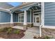 Inviting front porch with stone columns and white door at 1104 Maccoa Dr., Conway, SC 29526