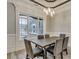 Bright dining room features a rustic wood table, gray chairs, and a large window at 1104 Maccoa Dr., Conway, SC 29526