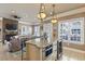 Open concept kitchen with island seating overlooks living room and fireplace at 6001 S Kings Hwy., Myrtle Beach, SC 29575