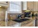 Kitchen features granite countertops, double sink, and modern appliances at 6001 S Kings Hwy., Myrtle Beach, SC 29575