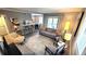 Open concept living room with grey sofa and access to a balcony at 10166 Beach Dr. # 5306, Calabash, NC 28467