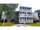 Exterior view of a three-story building with multiple balconies and lush landscaping at 10166 Beach Dr. # 5306, Calabash, NC 28467