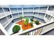 Ground level courtyard with tropical landscaping, surrounded by balconies at 10166 Beach Dr. # 5306, Calabash, NC 28467