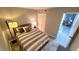 Cozy bedroom with striped bedding and floor lamp at 10166 Beach Dr. # 5306, Calabash, NC 28467