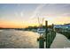 Sunset over calm waters with docked fishing boats creates a picturesque scene at 10166 Beach Dr. # 5306, Calabash, NC 28467