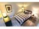 Bright bedroom with striped bedding and modern decor at 10166 Beach Dr. # 5306, Calabash, NC 28467
