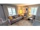 Living room with grey sofa and chairs, featuring large artwork at 10166 Beach Dr. # 5306, Calabash, NC 28467