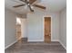 Bedroom with ceiling fan, wood-like floors, and access to bathroom at 3681 Claypond Rd. # 3107, Myrtle Beach, SC 29579
