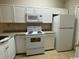 Bright kitchen features white cabinets, granite countertops, and white appliances at 3681 Claypond Rd. # 3107, Myrtle Beach, SC 29579