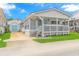 White beach cottage with a covered porch and green lawn at 6001-1424 S Kings Hwy., Myrtle Beach, SC 29575
