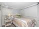 Bright bedroom with striped bedding and wicker furniture at 6001-1424 S Kings Hwy., Myrtle Beach, SC 29575