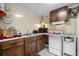 Efficient kitchen with wood cabinets, white appliances, and a microwave at 6001 - 5238 S Kings Hwy., Myrtle Beach, SC 29575