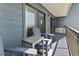 Private balcony with chairs and table, offering partial ocean view at 5905 S Kings Highway # 416-B, Myrtle Beach, SC 29575