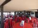 Indoor restaurant with red tables and chairs, a bar, and ocean views at 5905 S Kings Highway # 416-B, Myrtle Beach, SC 29575