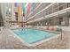 Inviting community pool with colorful chairs and surrounding patio at 5905 S Kings Highway # 416-B, Myrtle Beach, SC 29575
