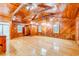 Spacious bedroom with wood walls, ceiling beams, and hardwood floors at 7122 Cox Lake Dr., Mullins, SC 29574