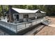 Gray and beige house exterior with a large deck and river views at 7122 Cox Lake Dr., Mullins, SC 29574