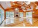 Living room with hardwood floors, wood walls, and sliding glass doors at 7122 Cox Lake Dr., Mullins, SC 29574
