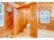 Small bathroom with toilet and wood walls at 7122 Cox Lake Dr., Mullins, SC 29574
