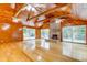 Spacious living room with hardwood floors, wood paneled walls, and a brick fireplace at 7122 Cox Lake Dr., Mullins, SC 29574