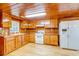 Simple kitchen with wood cabinets and white appliances at 7122 Cox Lake Dr., Mullins, SC 29574
