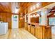 Kitchen with wood cabinets, island, and access to the backyard at 7122 Cox Lake Dr., Mullins, SC 29574