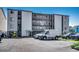 Three-story building exterior with parking and ocean views at 415 N Ocean Blvd. # 302, Surfside Beach, SC 29575