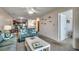Open living room with sofas, and a view of the kitchen at 415 N Ocean Blvd. # 302, Surfside Beach, SC 29575