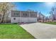 Three-car garage with upper-level windows and paved driveway at 7018 Cox Lake Ct., Mullins, SC 29574