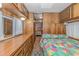 Bedroom with wood-paneled walls and a colorful bedspread at 6001-1359 S Kings Hwy., Myrtle Beach, SC 29575