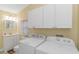 Bright bathroom with a toilet, sink, and storage cabinets at 6001-1359 S Kings Hwy., Myrtle Beach, SC 29575
