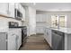 Modern kitchen with white cabinets, stainless steel appliances, and an island at 3022 Deerberry Place, Longs, SC 29568