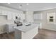 Modern kitchen with white cabinets, stainless steel appliances, and an island at 3022 Deerberry Place, Longs, SC 29568