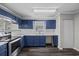 Modern kitchen with blue cabinets and granite counters at 4251 Villas Dr. # 309, Little River, SC 29566
