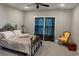Spacious bedroom with a comfortable bed, ample natural light, and a charming armchair at 949 Jackline Place # 103, Murrells Inlet, SC 29576