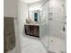 Modern bathroom with a large walk-in shower, double vanity, and marble tile at 949 Jackline Place # 103, Murrells Inlet, SC 29576