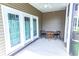 Screened-in patio with a small table and chairs, perfect for relaxing at 949 Jackline Place # 103, Murrells Inlet, SC 29576