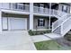 Two-story townhome exterior with white garage door and stairs at 949 Jackline Place # 103, Murrells Inlet, SC 29576