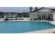 Community pool with adjacent patio and lounge chairs at 949 Jackline Place # 103, Murrells Inlet, SC 29576